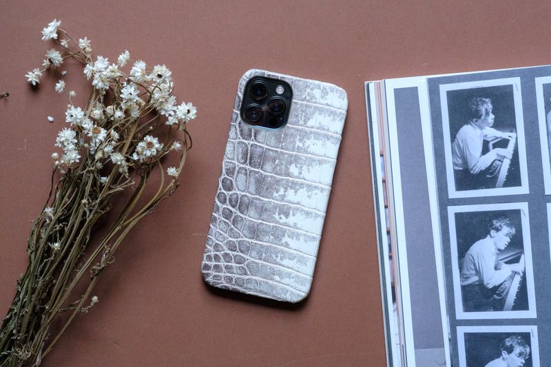 Premium custom phone case closeup showing vibrant print colors and precise camera cutout on a metal case