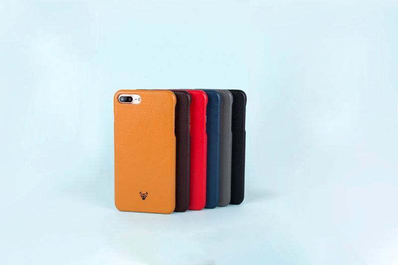 Close-up of a custom printed phone case being handled showing the print quality and texture