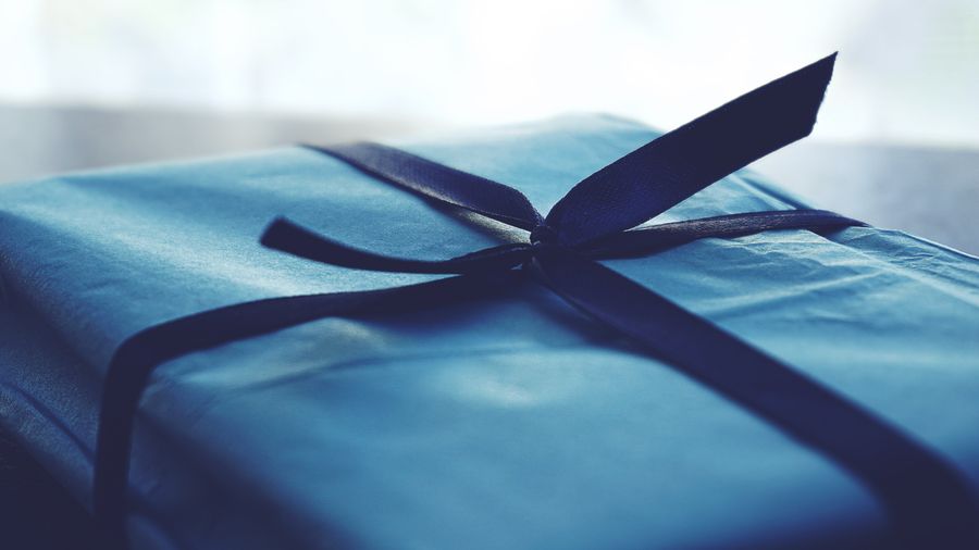A beautifully wrapped gift box with a ribbon, representing a name printed phone case gift