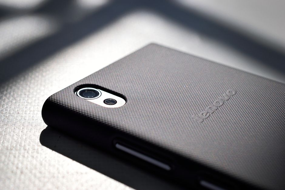 Close-up of a smartphone with a textured custom back cover showing the precision and quality possible with professional phone case design